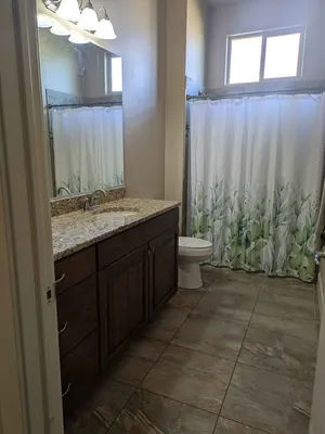 Clean, accessible bathroom with granite vanity